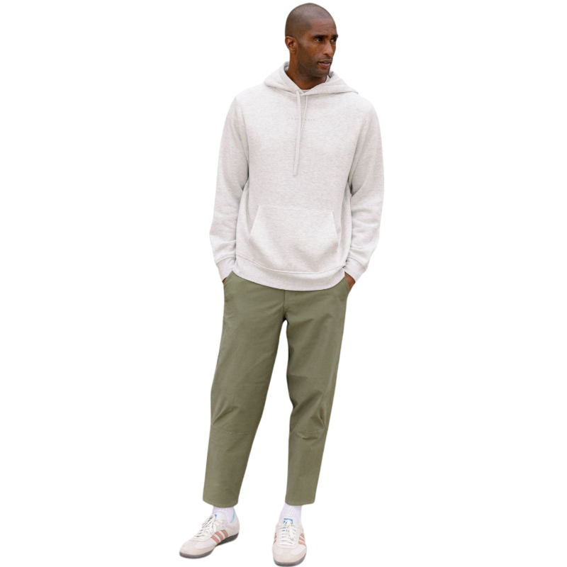 A person with curly hair is wearing a Cozy Earth Men's CityScape Hoodie in dark green and standing against a plain white background, with their hands together. |Color:Spruce