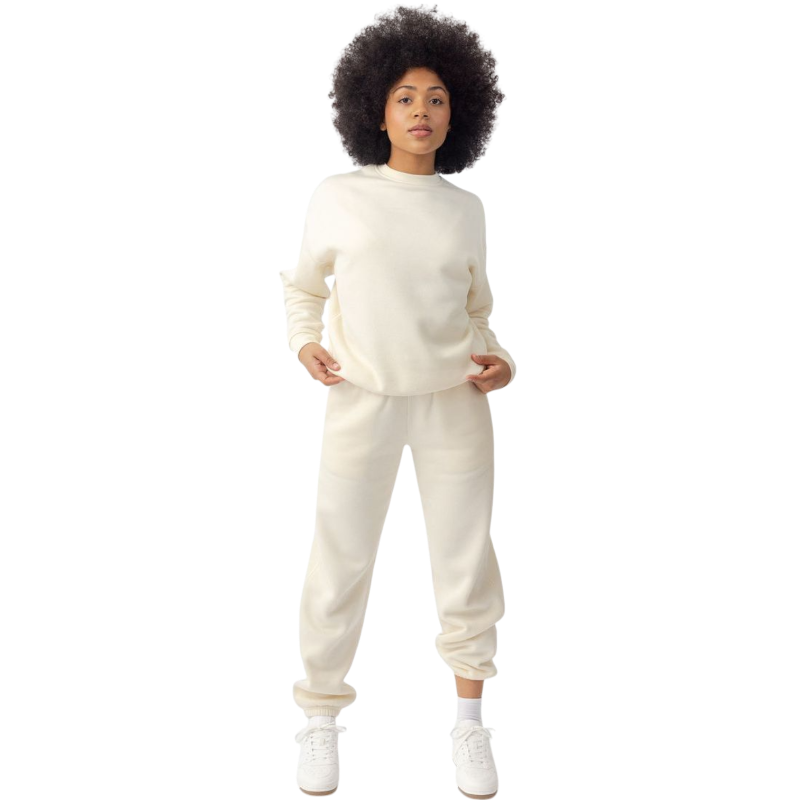 A person with curly hair models the Cozy Earth Women's CityScape Crewneck and matching pants in light pink against a plain white backdrop. |Color:Peony