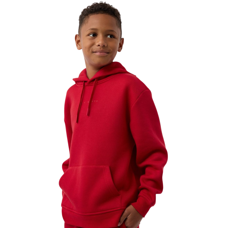 A child wearing a Kid's CityScape Hoodie by Cozy Earth smiles while looking to the side. The red hoodie features a front pocket against a plain white background. |Color:Crimson