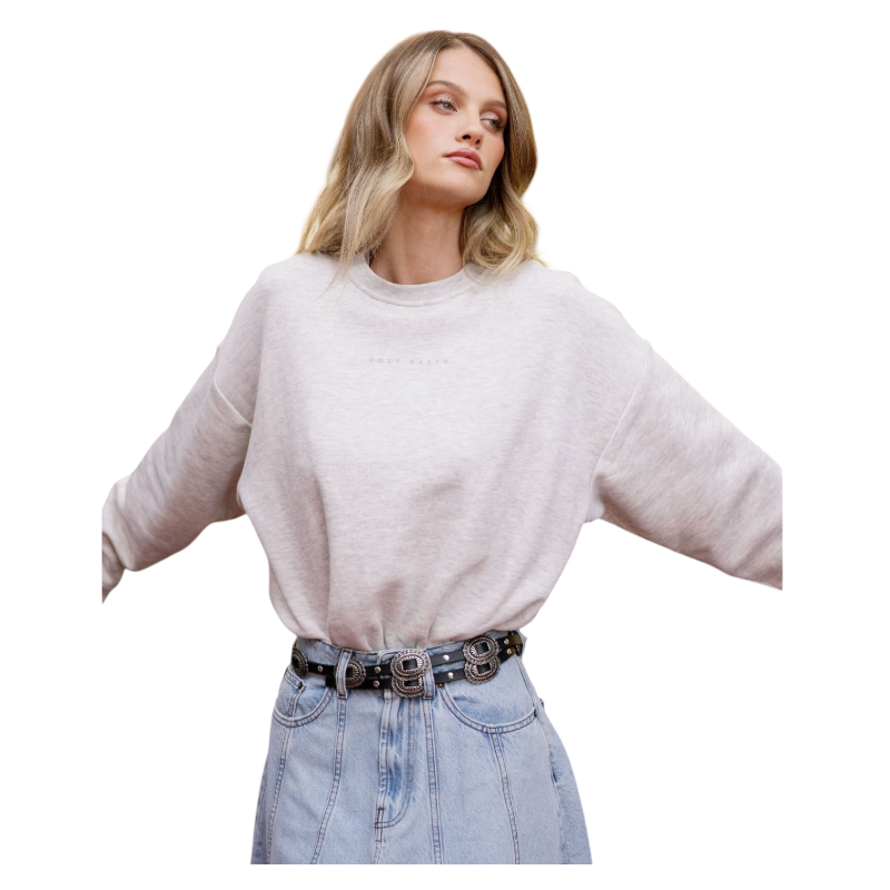 A person with curly hair models the Cozy Earth Women's CityScape Crewneck and matching pants in light pink against a plain white backdrop. |Color:Peony