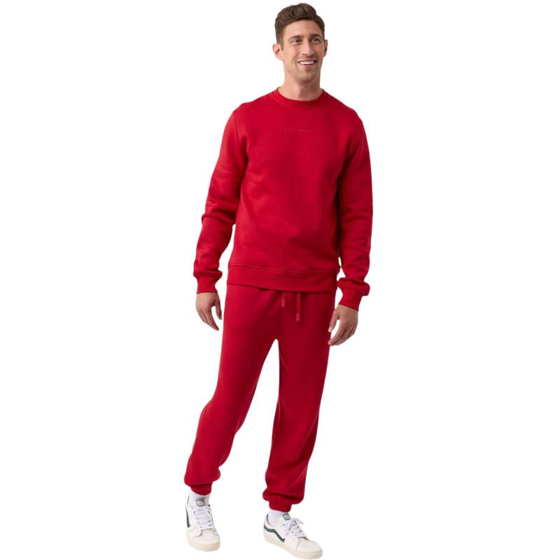 A man with short brown hair is wearing a dark green Men's CityScape Crewneck from Cozy Earth, featuring the words "COLD EARTH" printed on it. He is gazing slightly to the side against a plain white background. |Color:Spruce