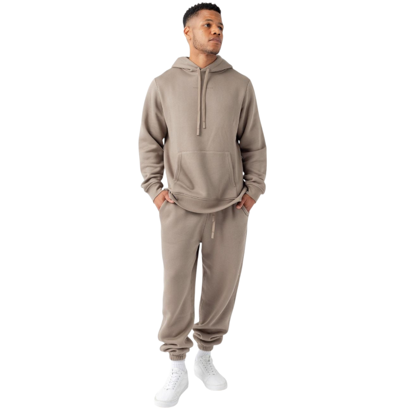 A person with curly hair is wearing a Cozy Earth Men's CityScape Hoodie in dark green and standing against a plain white background, with their hands together. |Color:Spruce