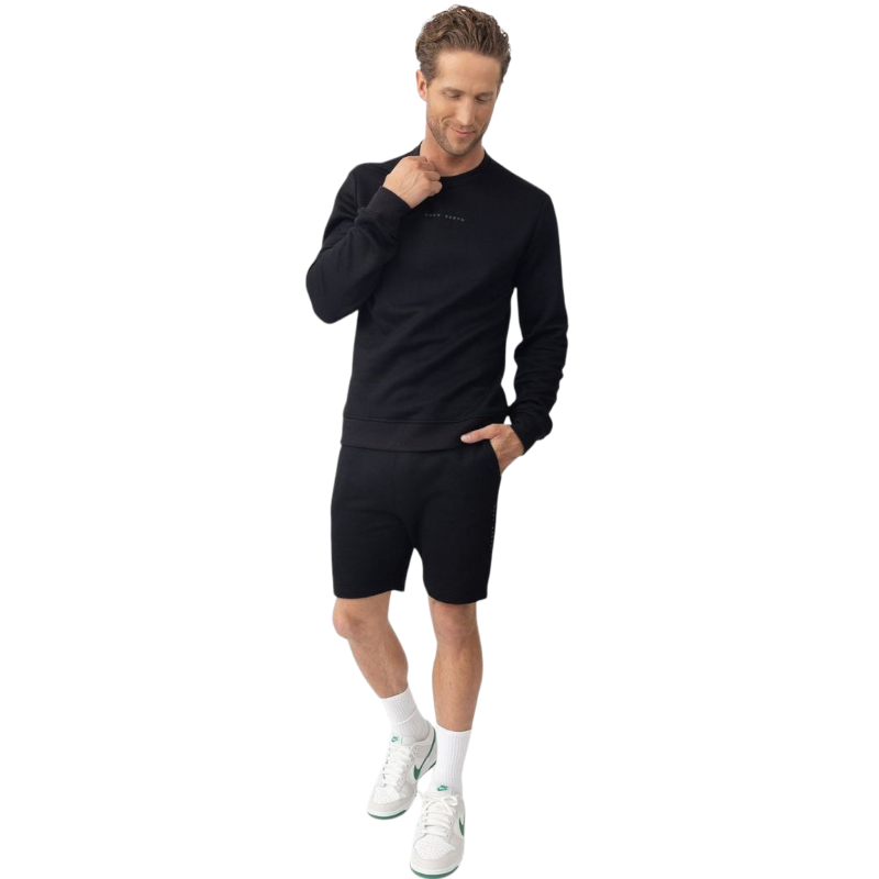 A man with short brown hair is wearing a dark green Men's CityScape Crewneck from Cozy Earth, featuring the words "COLD EARTH" printed on it. He is gazing slightly to the side against a plain white background. |Color:Spruce