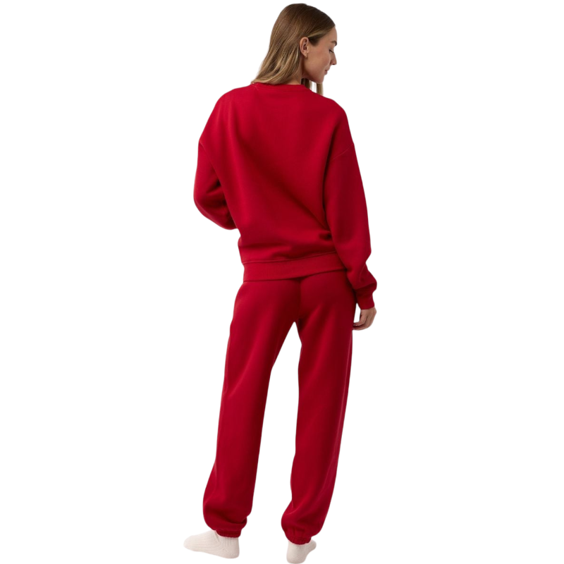 A person with curly hair models the Cozy Earth Women's CityScape Crewneck and matching pants in light pink against a plain white backdrop. |Color:Peony