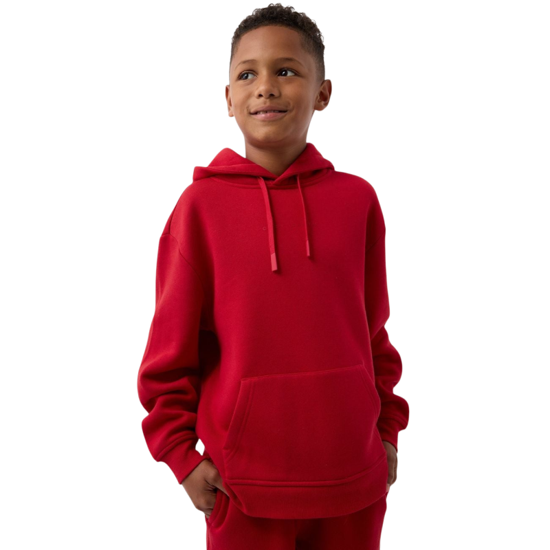 A young child with long blonde hair smiles while wearing a navy blue Kid's CityScape Hoodie by Cozy Earth and matching pants. She has two hair ties, one pink and one blue. The background is plain white. |Color:Eclipse