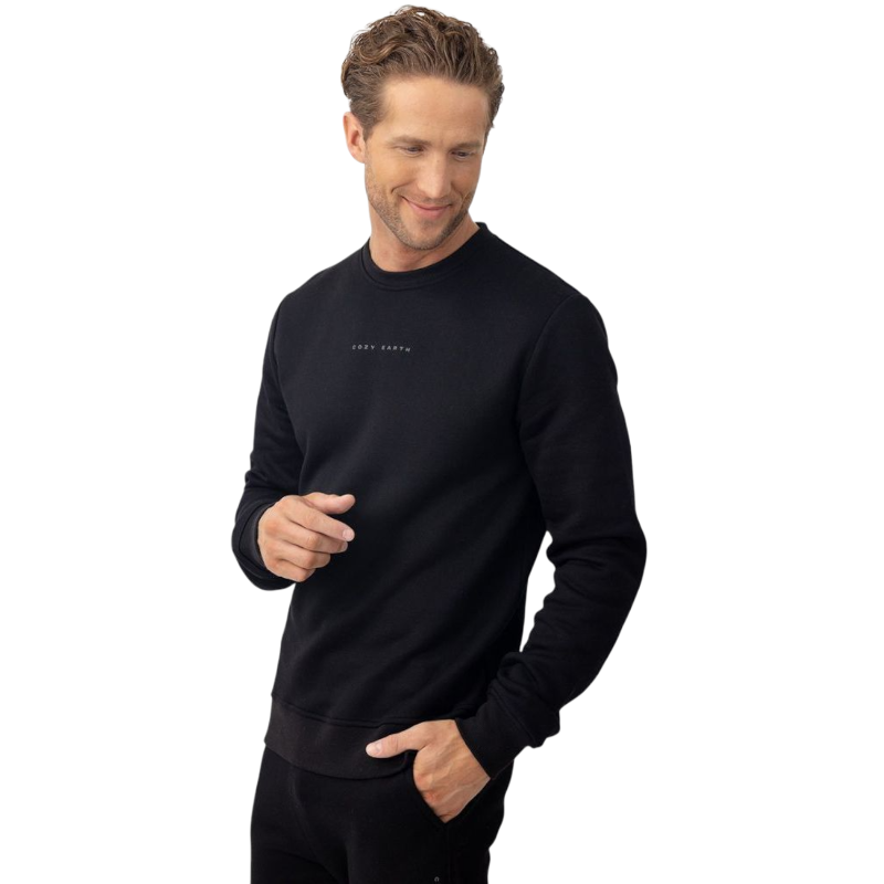 A man with short brown hair is wearing a dark green Men's CityScape Crewneck from Cozy Earth, featuring the words "COLD EARTH" printed on it. He is gazing slightly to the side against a plain white background. |Color:Spruce