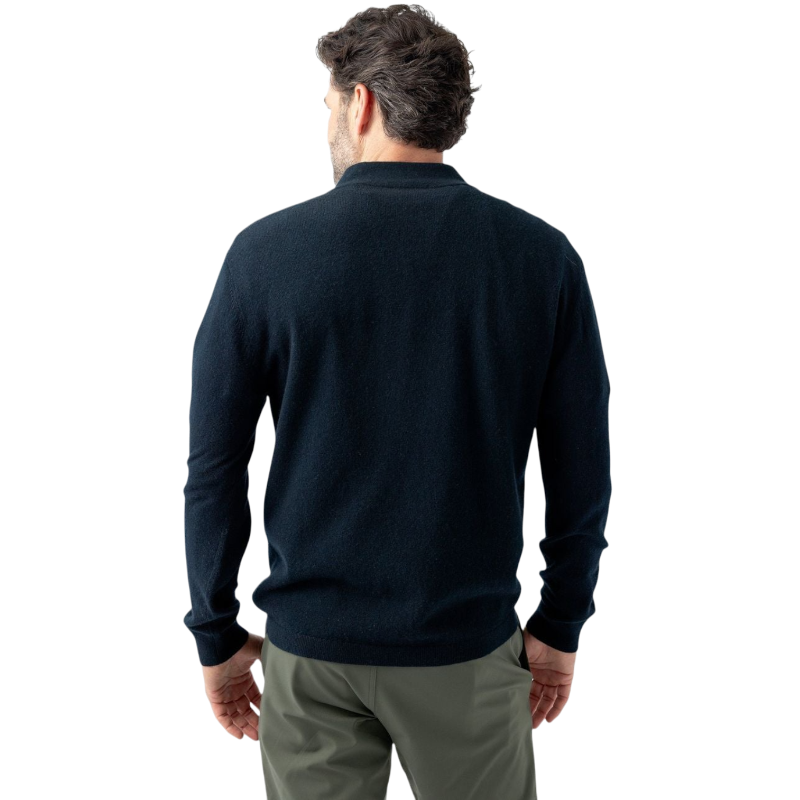 A man with dark hair and a short beard is wearing a navy blue Men's Quarter Zip Sweater from Cozy Earth paired with beige pants. He stands with his hands in his pockets against a plain white background, looking to his right with a slight smile. |Color:Eclipse