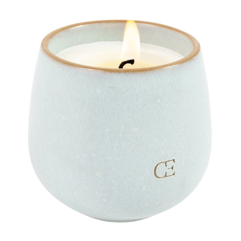 A young child with long blonde hair smiles while wearing a navy blue Kid's CityScape Hoodie by Cozy Earth and matching pants. She has two hair ties, one pink and one blue. The background is plain white. |Color:Eclipse