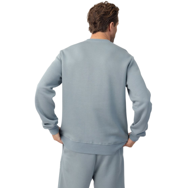 A man with short brown hair is wearing a dark green Men's CityScape Crewneck from Cozy Earth, featuring the words "COLD EARTH" printed on it. He is gazing slightly to the side against a plain white background. |Color:Spruce