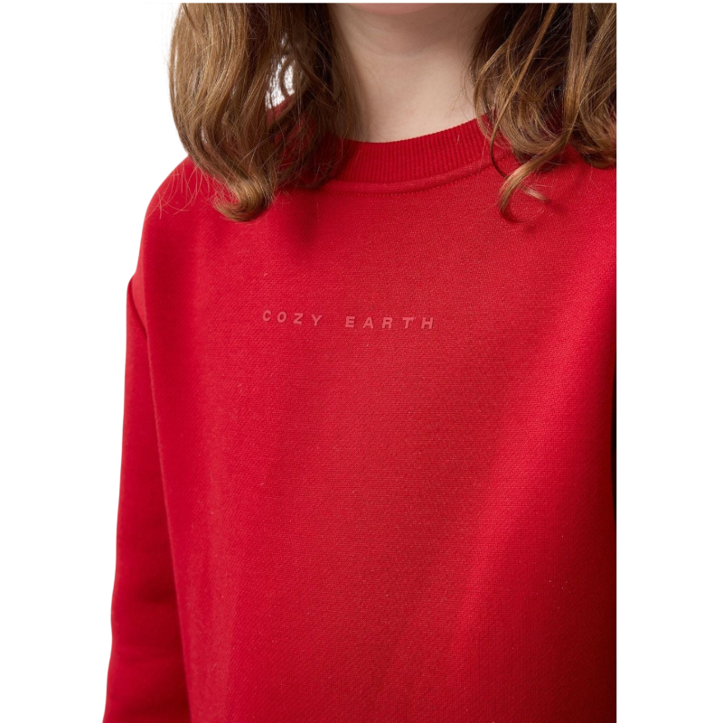 A young boy with blond hair is wearing the Cozy Earth Kid's CityScape Crewneck sweatshirt along with matching pants. He is standing, smiling, and looking slightly to the side against a plain white background. |Color:Eclipse