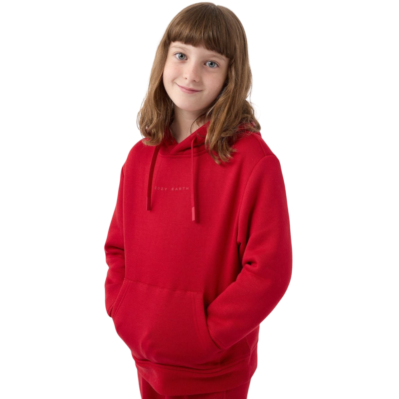 A young child with long blonde hair smiles while wearing a navy blue Kid's CityScape Hoodie by Cozy Earth and matching pants. She has two hair ties, one pink and one blue. The background is plain white. |Color:Eclipse
