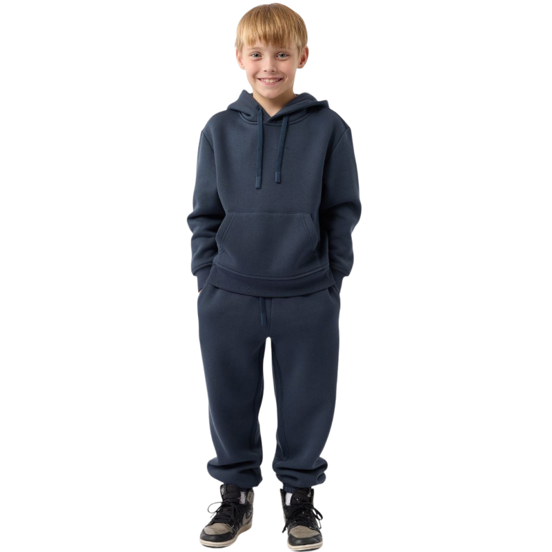 A young child with long blonde hair smiles while wearing a navy blue Kid's CityScape Hoodie by Cozy Earth and matching pants. She has two hair ties, one pink and one blue. The background is plain white. |Color:Eclipse