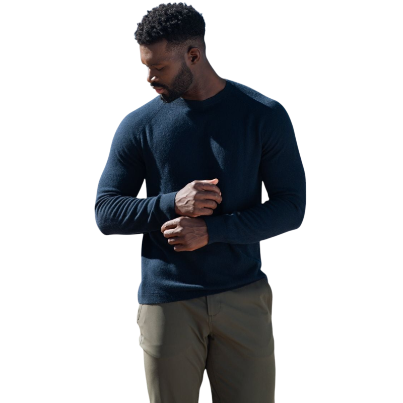 A man with dark hair and a beard stands casually with his hands in his pockets. He is wearing the Cozy Earth Men's Crewneck Sweater in navy blue, paired with gray pants. He looks at the camera with a neutral expression, set against a plain white background. |Color:Eclipse