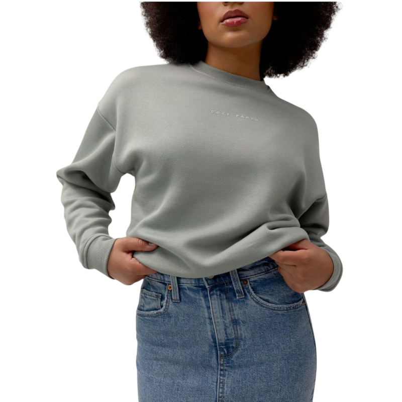 A person with curly hair models the Cozy Earth Women's CityScape Crewneck and matching pants in light pink against a plain white backdrop. |Color:Peony