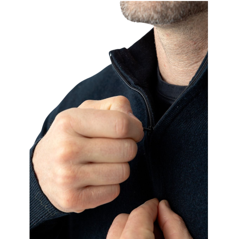 A man with dark hair and a short beard is wearing a navy blue Men's Quarter Zip Sweater from Cozy Earth paired with beige pants. He stands with his hands in his pockets against a plain white background, looking to his right with a slight smile. |Color:Eclipse