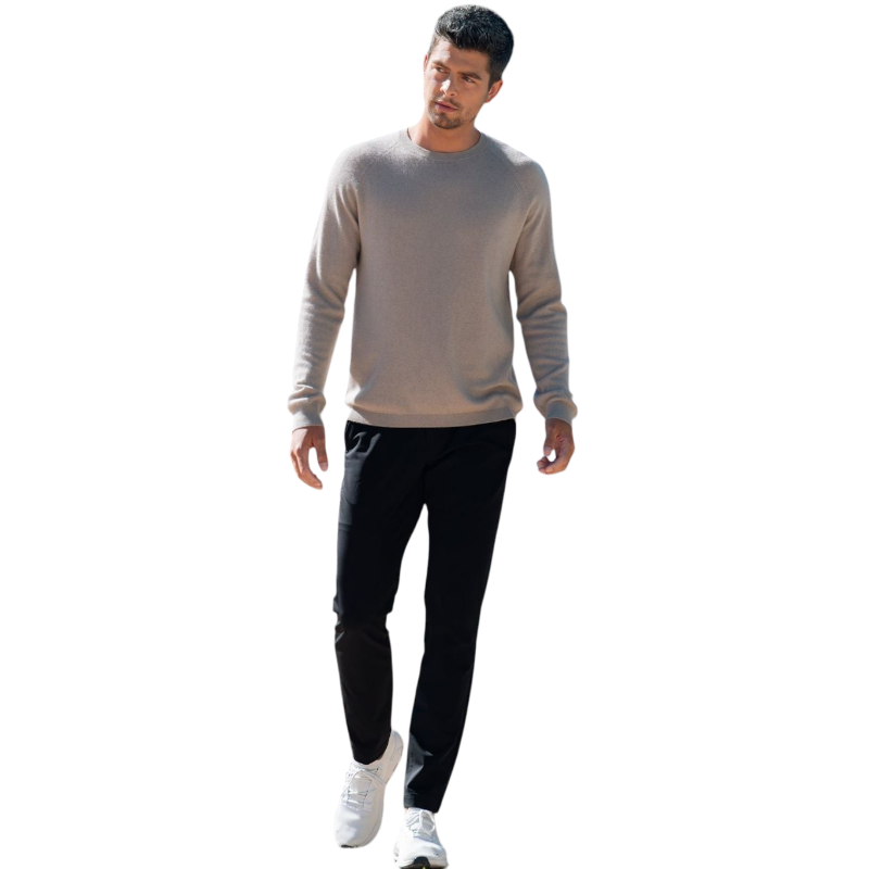 A man with dark hair and a beard stands casually with his hands in his pockets. He is wearing the Cozy Earth Men's Crewneck Sweater in navy blue, paired with gray pants. He looks at the camera with a neutral expression, set against a plain white background. |Color:Eclipse
