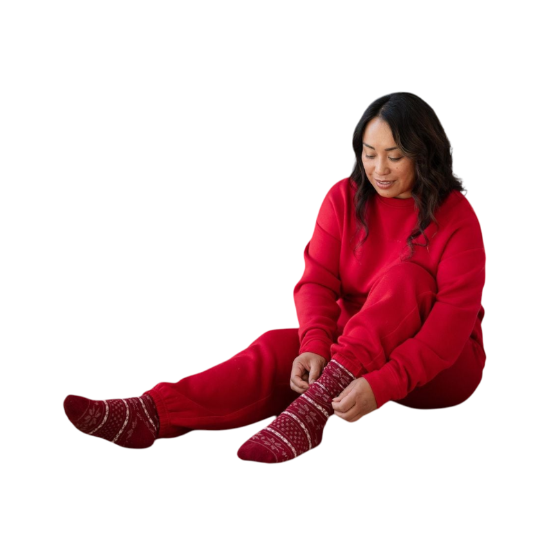 A person with curly hair models the Cozy Earth Women's CityScape Crewneck and matching pants in light pink against a plain white backdrop. |Color:Peony