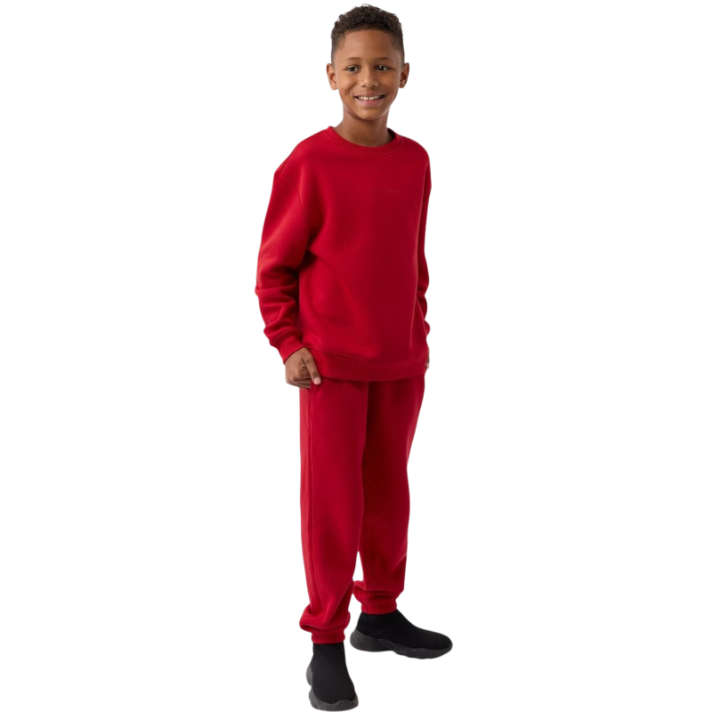 A young boy with blond hair is wearing the Cozy Earth Kid's CityScape Crewneck sweatshirt along with matching pants. He is standing, smiling, and looking slightly to the side against a plain white background. |Color:Eclipse