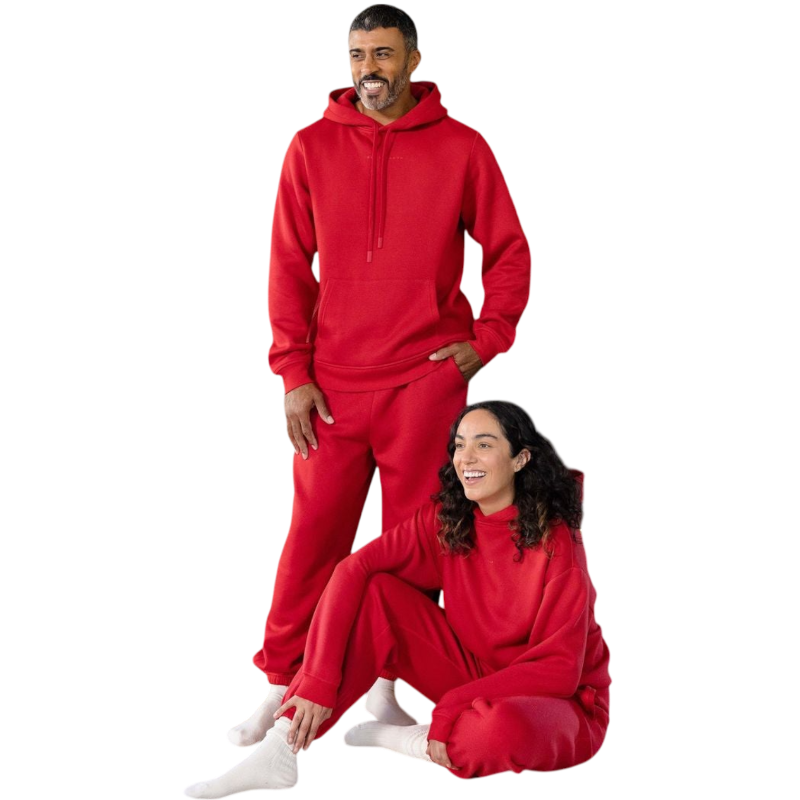 A person with curly hair is wearing a Cozy Earth Men's CityScape Hoodie in dark green and standing against a plain white background, with their hands together. |Color:Spruce