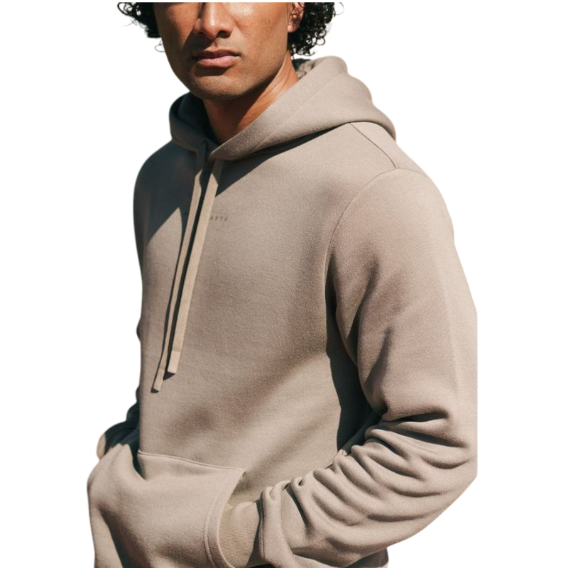 A person with curly hair is wearing a Cozy Earth Men's CityScape Hoodie in dark green and standing against a plain white background, with their hands together. |Color:Spruce