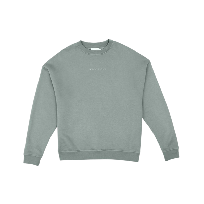 A person with curly hair models the Cozy Earth Women's CityScape Crewneck and matching pants in light pink against a plain white backdrop. |Color:Peony