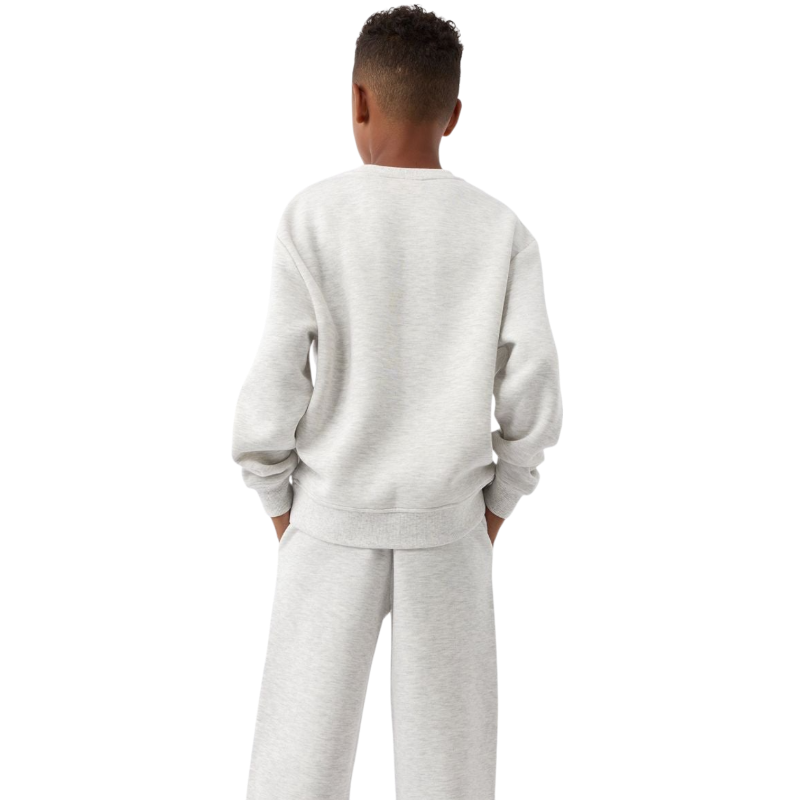 A young boy with blond hair is wearing the Cozy Earth Kid's CityScape Crewneck sweatshirt along with matching pants. He is standing, smiling, and looking slightly to the side against a plain white background. |Color:Eclipse