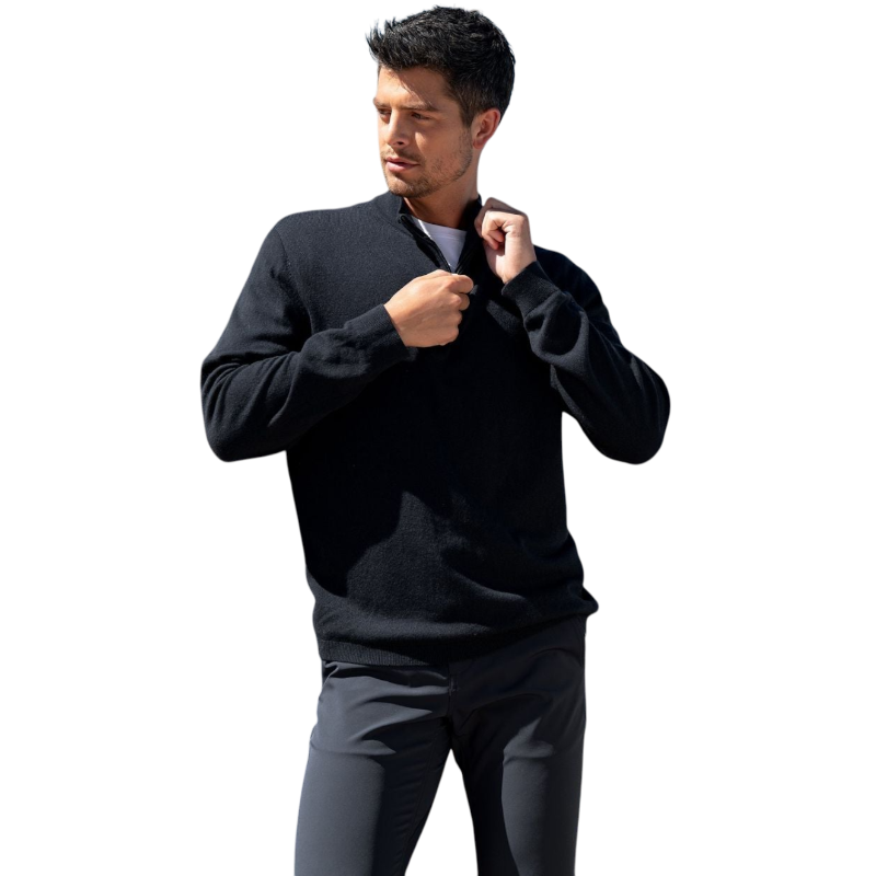 A man with dark hair and a short beard is wearing a navy blue Men's Quarter Zip Sweater from Cozy Earth paired with beige pants. He stands with his hands in his pockets against a plain white background, looking to his right with a slight smile. |Color:Eclipse