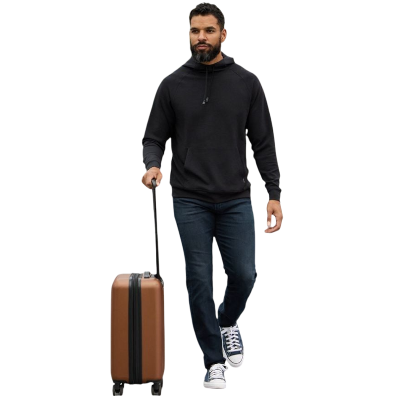 A person wearing the Men's StretchTech Hoodie from Cozy Earth, paired with matching gray pants, stands against a plain white background. The hoodie features drawstrings and a front pocket. The individual is looking forward with a neutral expression. |Color:Coal Heather