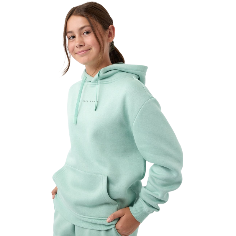 A young child with long blonde hair smiles while wearing a navy blue Kid's CityScape Hoodie by Cozy Earth and matching pants. She has two hair ties, one pink and one blue. The background is plain white. |Color:Eclipse