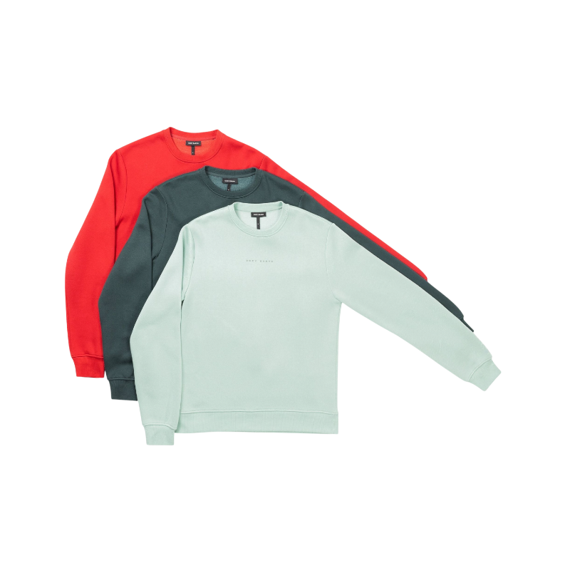 A man with short brown hair is wearing a dark green Men's CityScape Crewneck from Cozy Earth, featuring the words "COLD EARTH" printed on it. He is gazing slightly to the side against a plain white background. |Color:Spruce