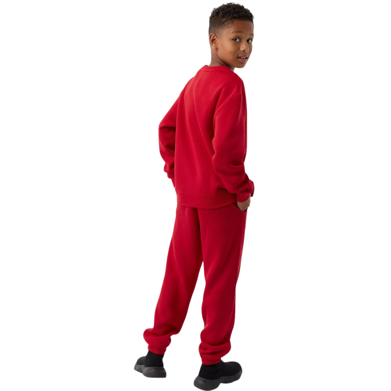 A young boy with blond hair is wearing the Cozy Earth Kid's CityScape Crewneck sweatshirt along with matching pants. He is standing, smiling, and looking slightly to the side against a plain white background. |Color:Eclipse