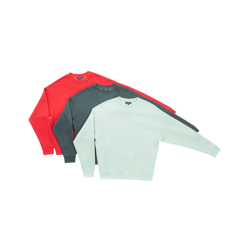 A person with curly hair models the Cozy Earth Women's CityScape Crewneck and matching pants in light pink against a plain white backdrop. |Color:Peony