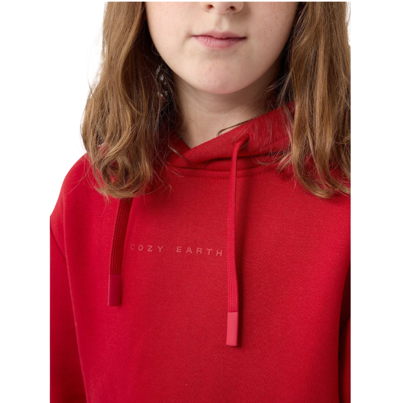 A young child with long blonde hair smiles while wearing a navy blue Kid's CityScape Hoodie by Cozy Earth and matching pants. She has two hair ties, one pink and one blue. The background is plain white. |Color:Eclipse