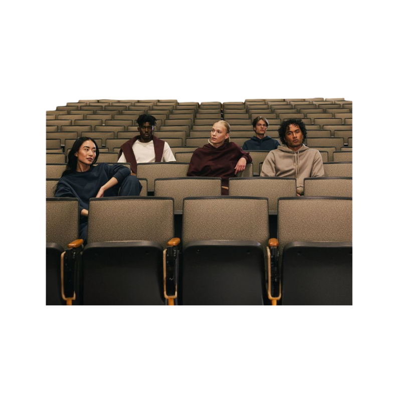 A person with curly hair models the Cozy Earth Women's CityScape Crewneck and matching pants in light pink against a plain white backdrop. |Color:Peony