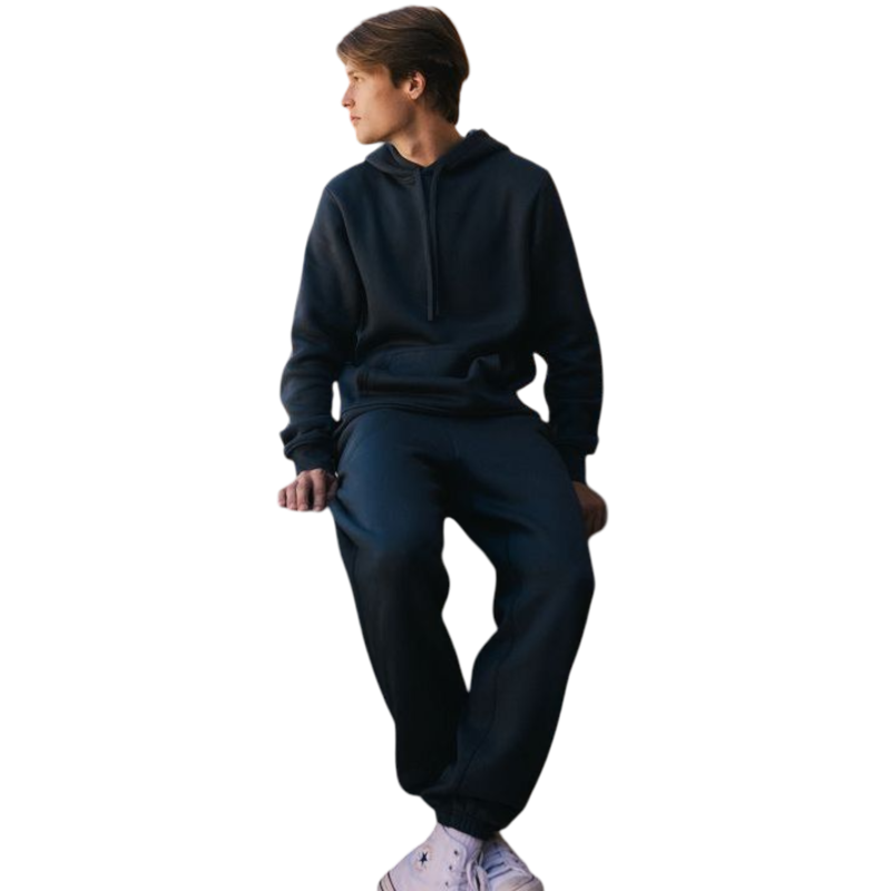 A person with curly hair is wearing a Cozy Earth Men's CityScape Hoodie in dark green and standing against a plain white background, with their hands together. |Color:Spruce