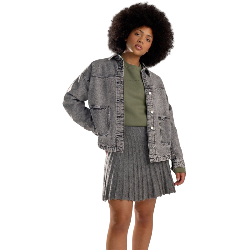 A person with curly hair models the Cozy Earth Women's CityScape Crewneck and matching pants in light pink against a plain white backdrop. |Color:Peony