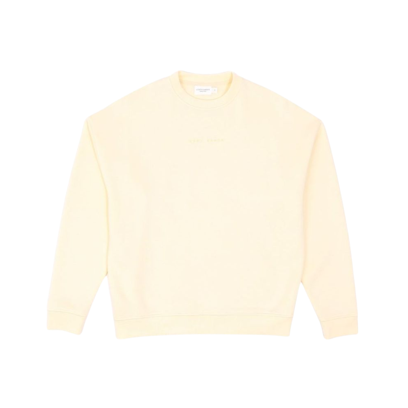 A person with curly hair models the Cozy Earth Women's CityScape Crewneck and matching pants in light pink against a plain white backdrop. |Color:Peony