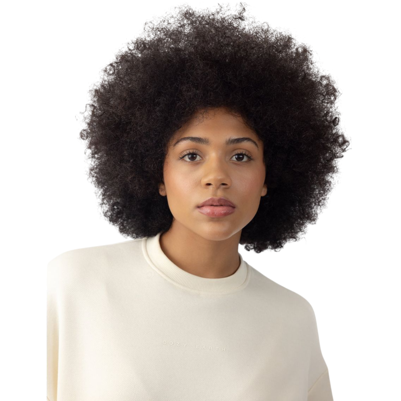 A person with curly hair models the Cozy Earth Women's CityScape Crewneck and matching pants in light pink against a plain white backdrop. |Color:Peony