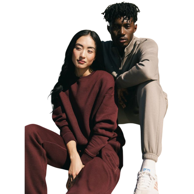 A person with curly hair models the Cozy Earth Women's CityScape Crewneck and matching pants in light pink against a plain white backdrop. |Color:Peony