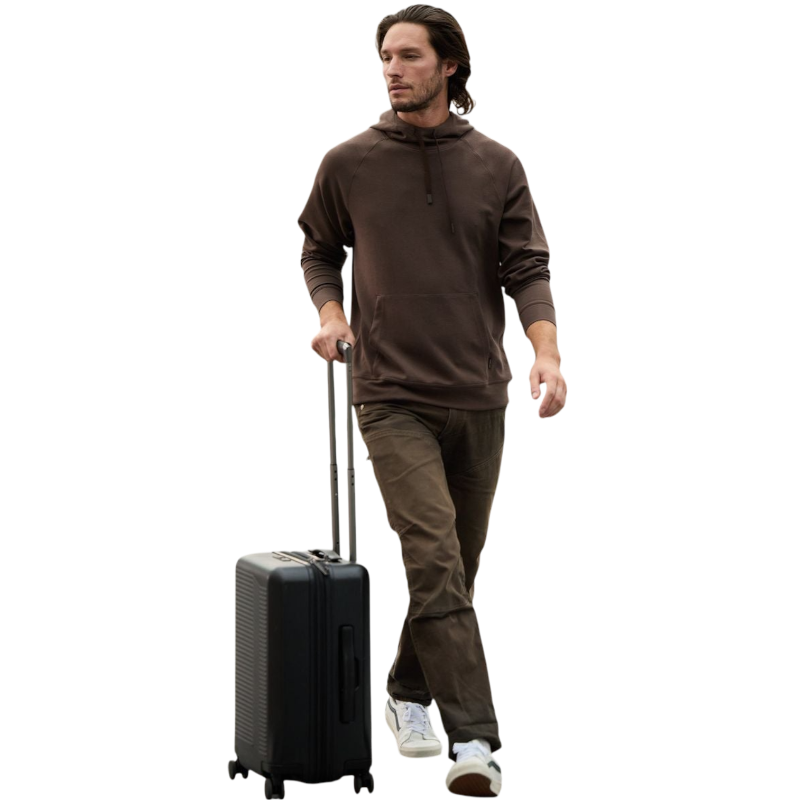 A person wearing the Men's StretchTech Hoodie from Cozy Earth, paired with matching gray pants, stands against a plain white background. The hoodie features drawstrings and a front pocket. The individual is looking forward with a neutral expression. |Color:Coal Heather