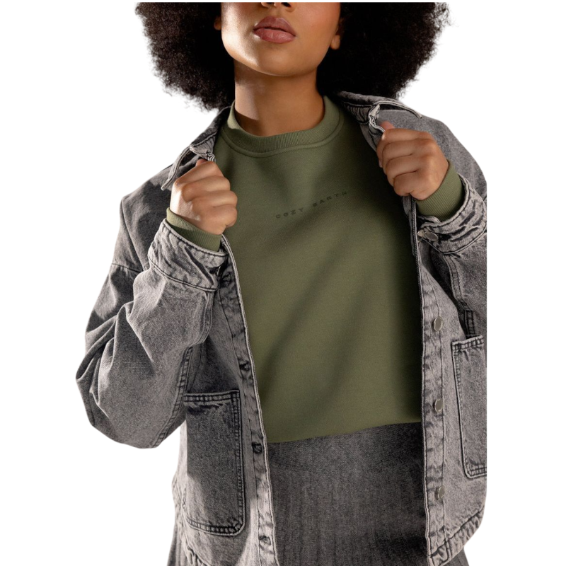 A person with curly hair models the Cozy Earth Women's CityScape Crewneck and matching pants in light pink against a plain white backdrop. |Color:Peony