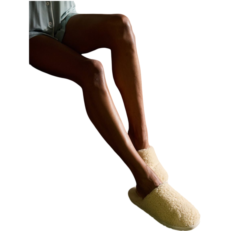 A pair of Puffy Sheep Slippers by Cozy Earth, featuring a cozy tan design with a fuzzy, textured exterior and soft interior, crafted in a slip-on style with rubber soles, set against a plain white background. |Color:Fawn