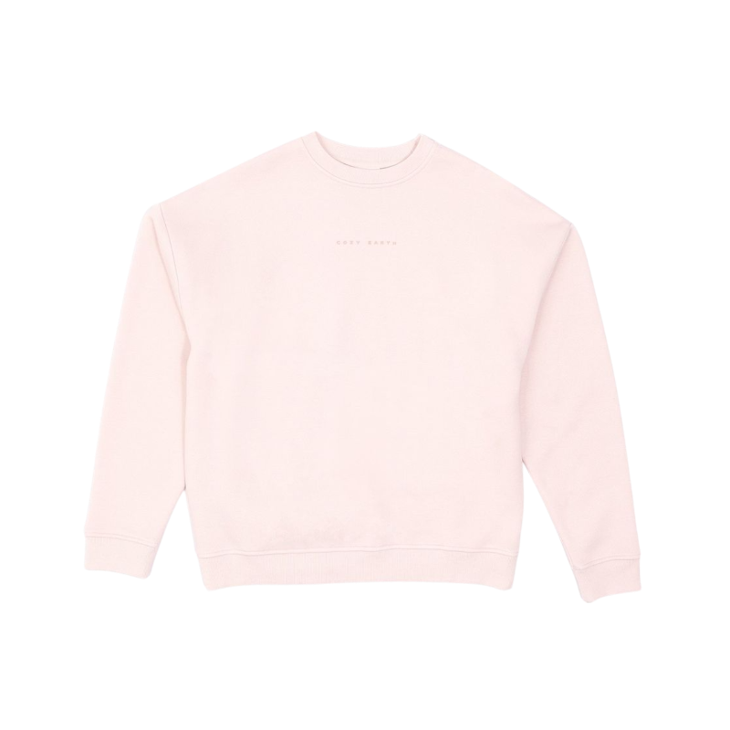 A person with curly hair models the Cozy Earth Women's CityScape Crewneck and matching pants in light pink against a plain white backdrop. |Color:Peony