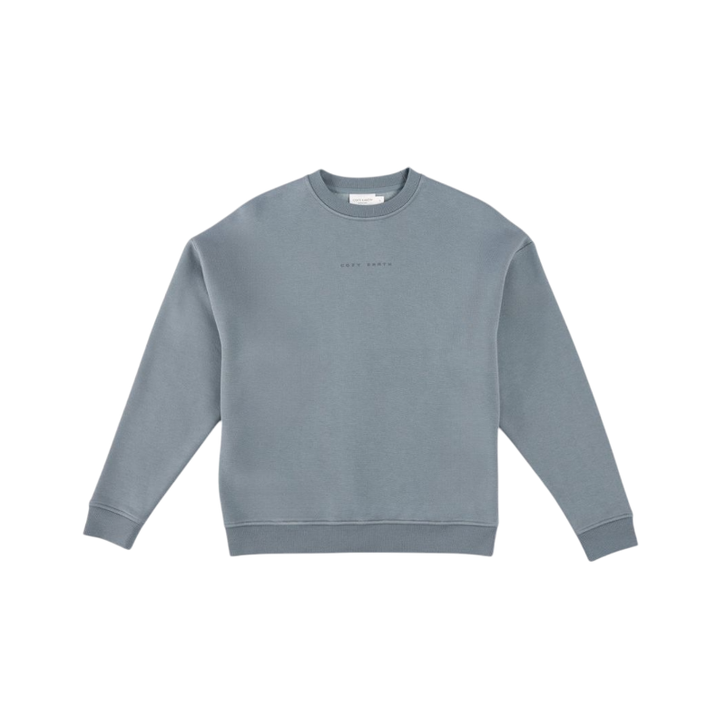 A man with short brown hair is wearing a dark green Men's CityScape Crewneck from Cozy Earth, featuring the words "COLD EARTH" printed on it. He is gazing slightly to the side against a plain white background. |Color:Spruce