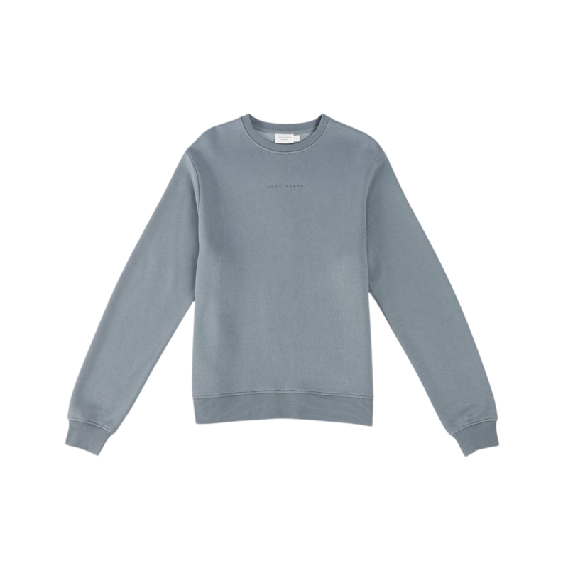 A person with curly hair models the Cozy Earth Women's CityScape Crewneck and matching pants in light pink against a plain white backdrop. |Color:Peony