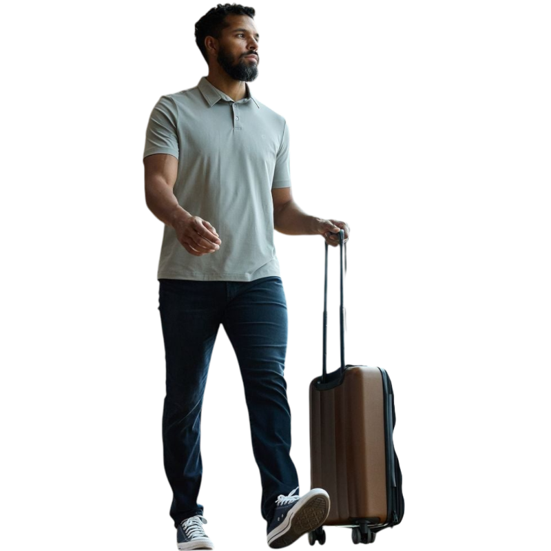 A person with short, light brown hair is wearing the Men's Everyday Polo by Cozy Earth in a light gray shade, paired with light beige pants. They are standing and slightly looking over their left shoulder with a neutral expression against a plain white background. |Color:Stone