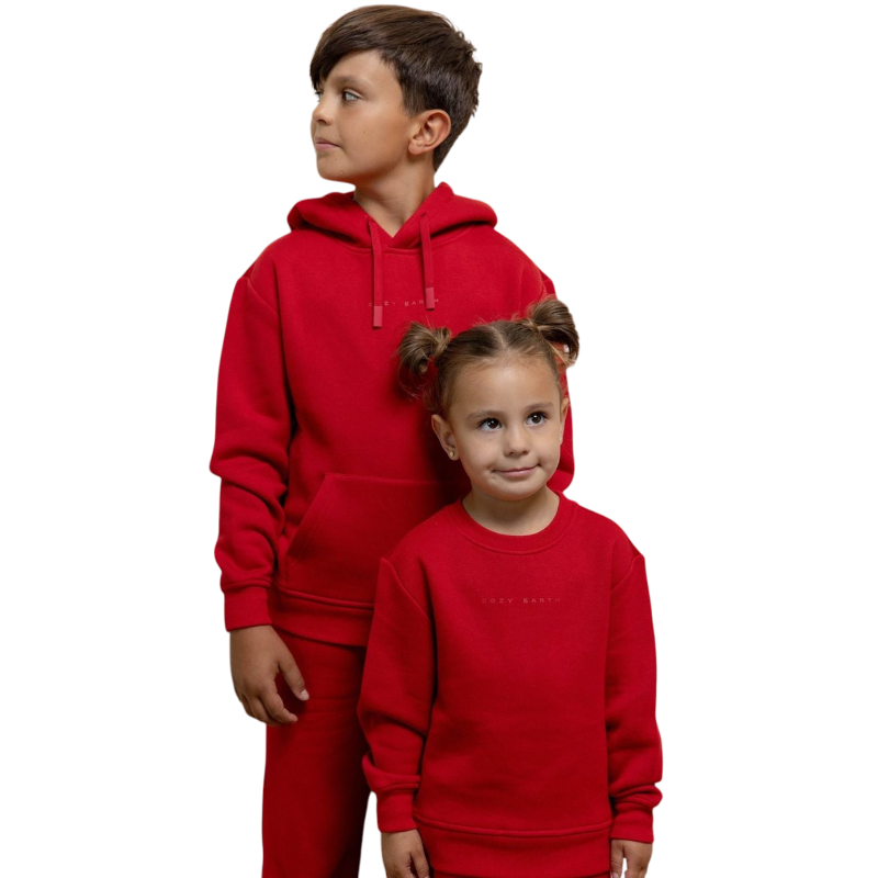 A young boy with blond hair is wearing the Cozy Earth Kid's CityScape Crewneck sweatshirt along with matching pants. He is standing, smiling, and looking slightly to the side against a plain white background. |Color:Eclipse