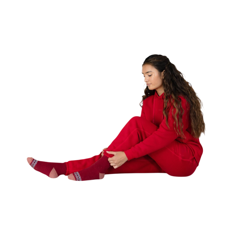 A young child with long blonde hair smiles while wearing a navy blue Kid's CityScape Hoodie by Cozy Earth and matching pants. She has two hair ties, one pink and one blue. The background is plain white. |Color:Eclipse