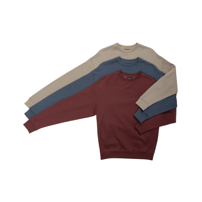 A person with curly hair models the Cozy Earth Women's CityScape Crewneck and matching pants in light pink against a plain white backdrop. |Color:Peony