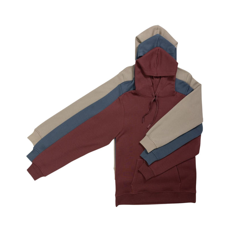 A person with curly hair is wearing a Cozy Earth Men's CityScape Hoodie in dark green and standing against a plain white background, with their hands together. |Color:Spruce